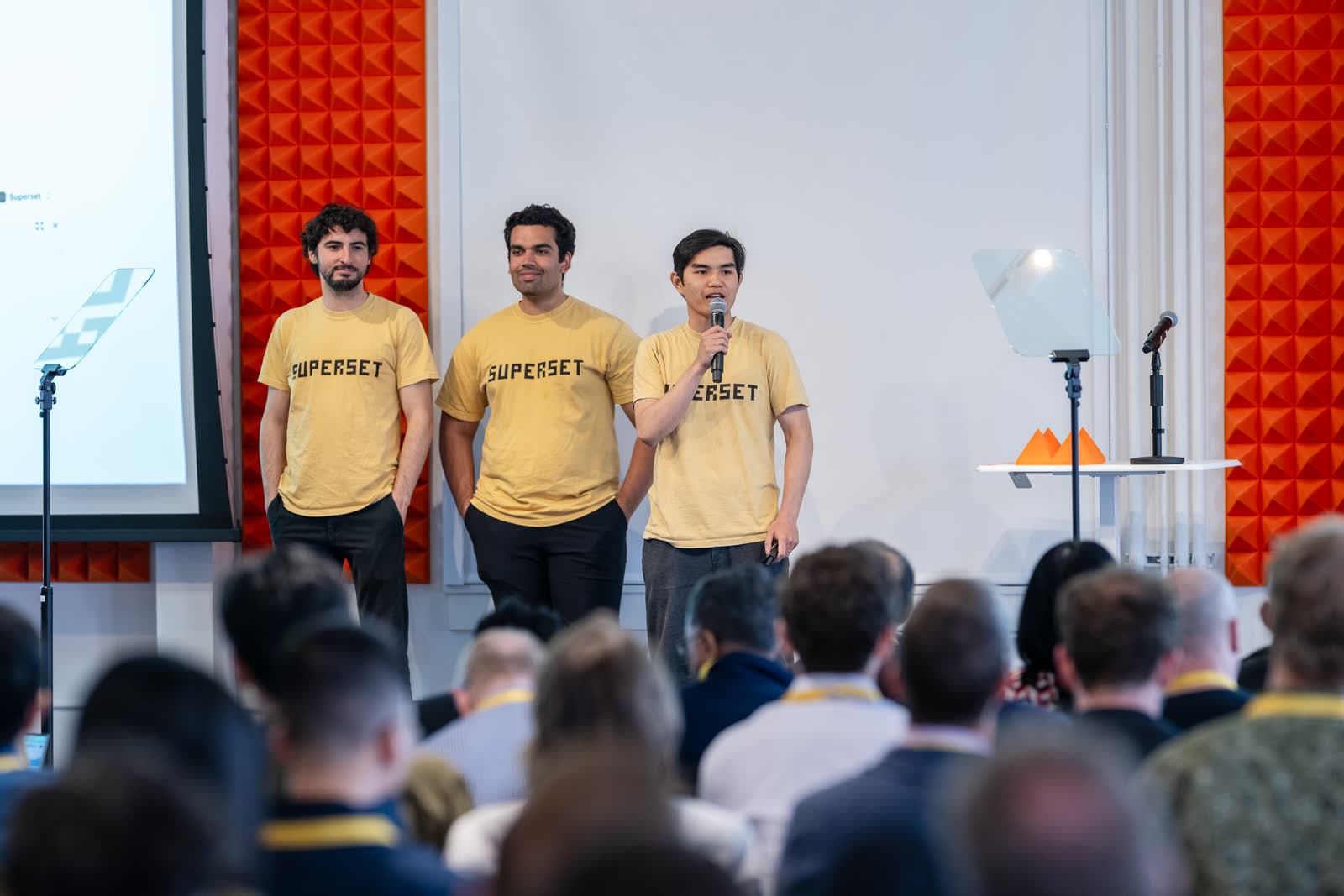 Avi, Satya, and Kiet on stage in Superset shirts at Y Combinator Demo Day